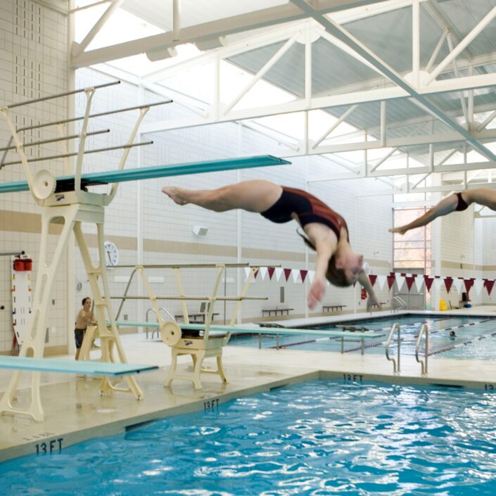 two divers at swimming pool