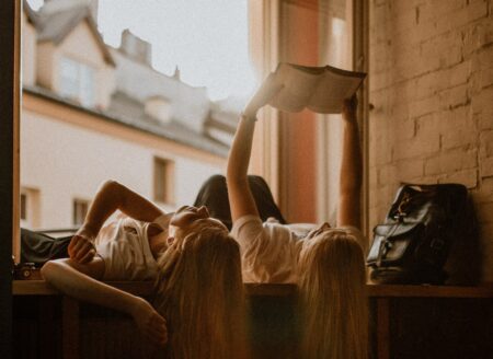 girls reading in window